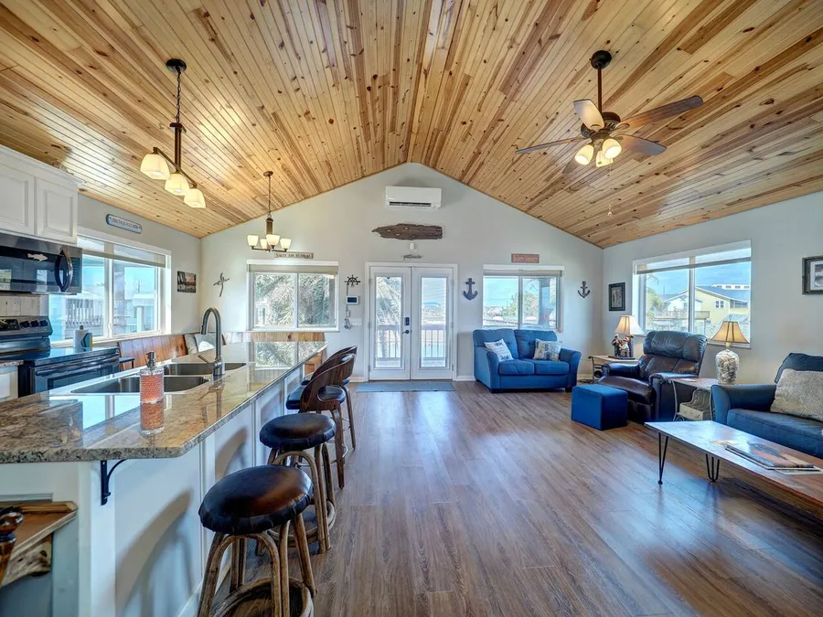 Open-plan kitchen and living room with a long island at the Rockport house